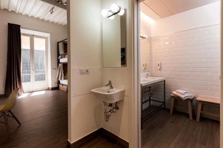 A clean 6-bed mixed dorm room with bunk beds